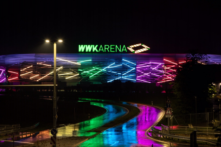 WWK ARENA glowing in a colorful light